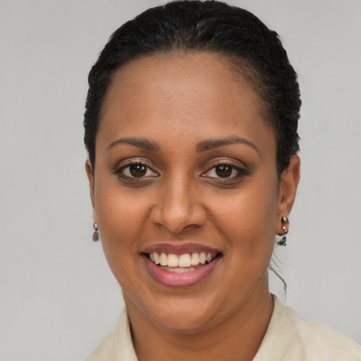 Joyful black young-adult female with short  brown hair and brown eyes
