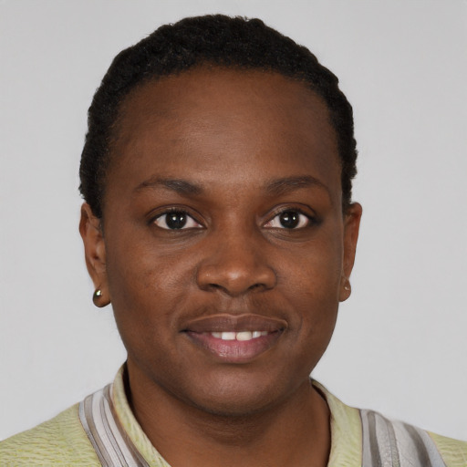 Joyful black young-adult female with short  brown hair and brown eyes