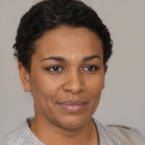 Joyful black adult female with short  brown hair and brown eyes