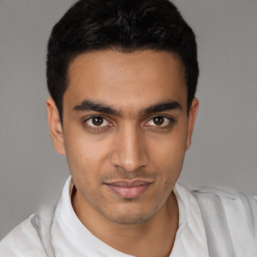 Joyful latino young-adult male with short  black hair and brown eyes