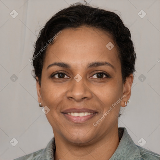 Joyful latino adult female with short  brown hair and brown eyes