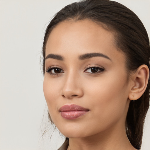 Joyful latino young-adult female with long  brown hair and brown eyes