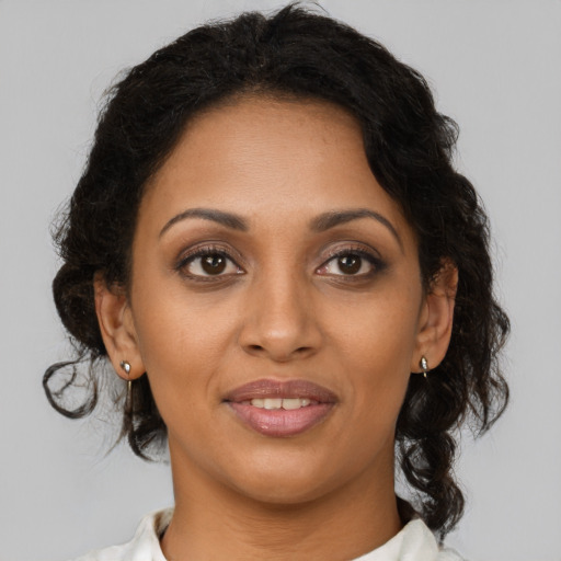 Joyful black young-adult female with medium  brown hair and brown eyes