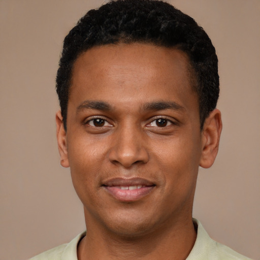 Joyful black young-adult male with short  black hair and brown eyes