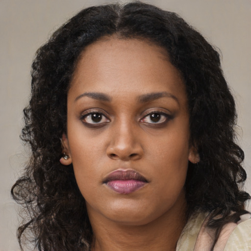 Neutral black young-adult female with long  brown hair and brown eyes
