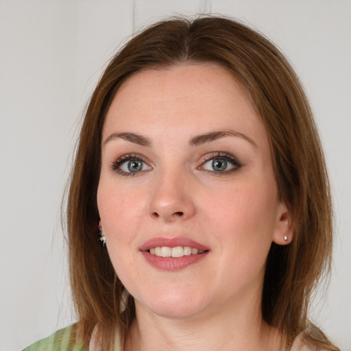 Joyful white young-adult female with medium  brown hair and blue eyes