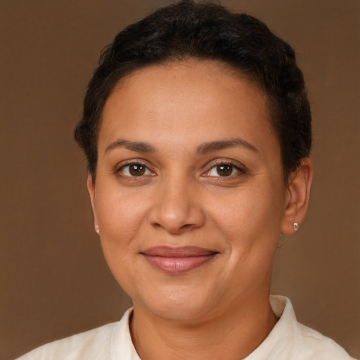 Joyful latino adult female with short  brown hair and brown eyes