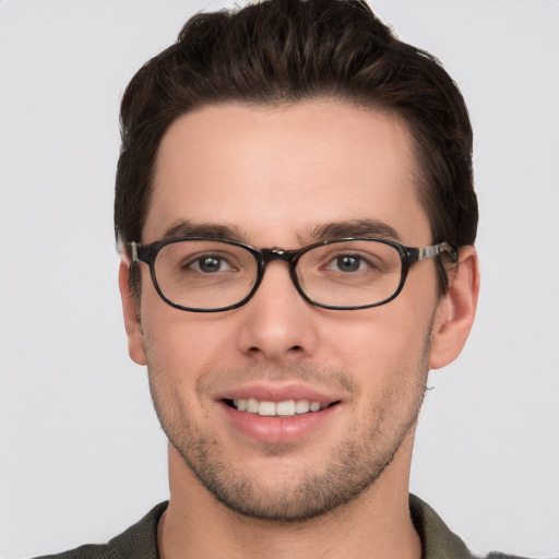 Joyful white young-adult male with short  brown hair and grey eyes