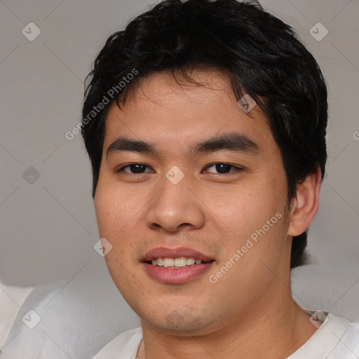 Joyful asian young-adult male with short  brown hair and brown eyes