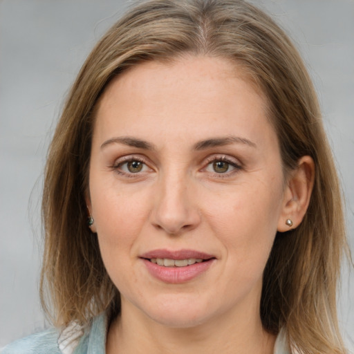 Joyful white adult female with medium  brown hair and brown eyes