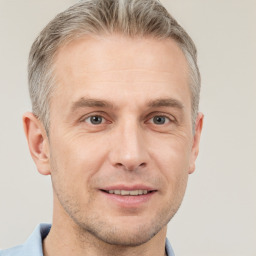 Joyful white adult male with short  brown hair and grey eyes