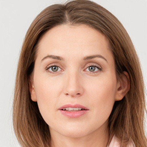 Joyful white young-adult female with long  brown hair and grey eyes