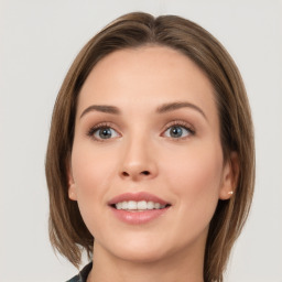 Joyful white young-adult female with medium  brown hair and green eyes