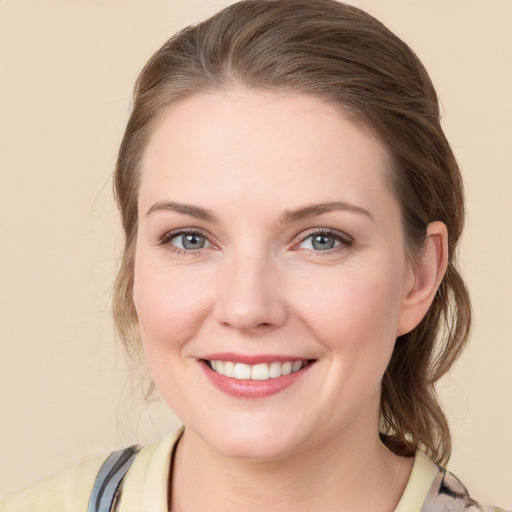 Joyful white young-adult female with medium  brown hair and blue eyes