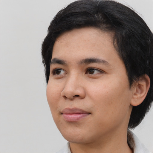 Joyful white young-adult male with medium  black hair and brown eyes