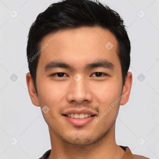 Joyful asian young-adult male with short  black hair and brown eyes