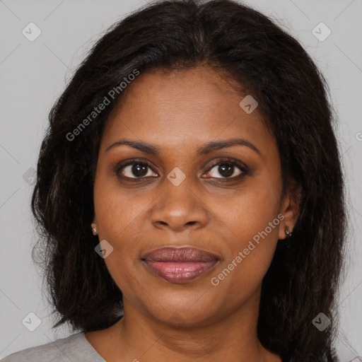 Joyful black young-adult female with long  brown hair and brown eyes