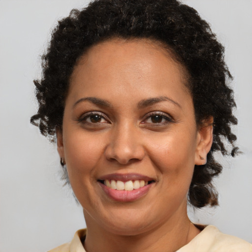 Joyful latino adult female with short  brown hair and brown eyes