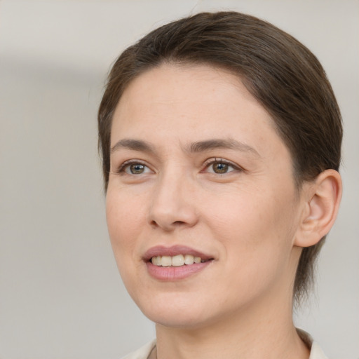 Joyful white young-adult female with medium  brown hair and brown eyes