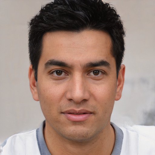 Joyful white young-adult male with short  black hair and brown eyes