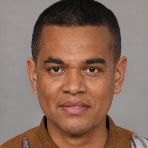 Joyful black young-adult male with short  black hair and brown eyes