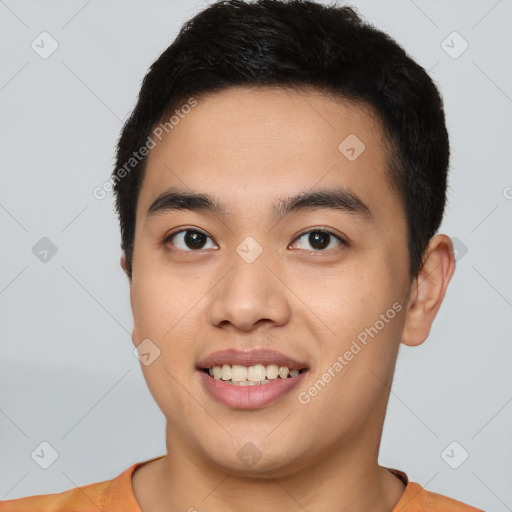 Joyful asian young-adult male with short  black hair and brown eyes