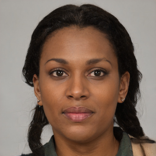 Joyful black young-adult female with medium  brown hair and brown eyes