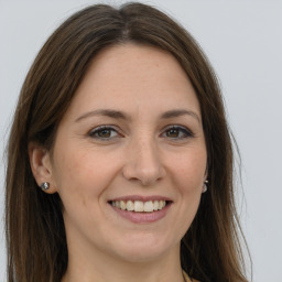 Joyful white young-adult female with long  brown hair and grey eyes