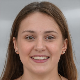 Joyful white young-adult female with long  brown hair and grey eyes