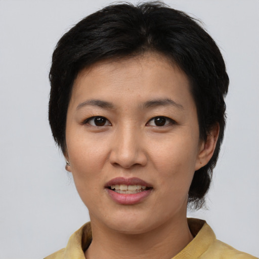 Joyful asian young-adult female with medium  brown hair and brown eyes