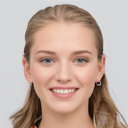 Joyful white young-adult female with long  brown hair and blue eyes