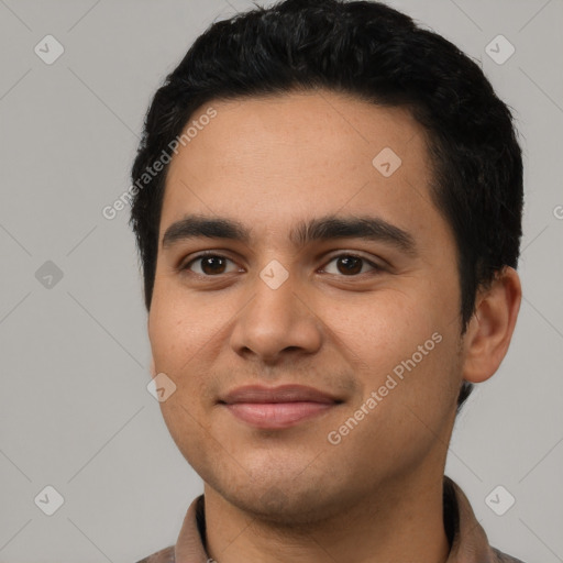 Joyful latino young-adult male with short  black hair and brown eyes