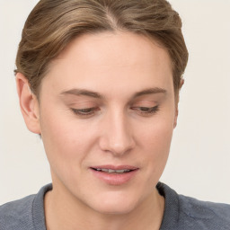 Joyful white young-adult female with short  brown hair and blue eyes