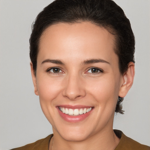 Joyful white young-adult female with short  brown hair and brown eyes