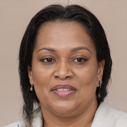 Joyful black adult female with medium  brown hair and brown eyes
