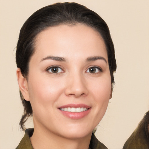 Joyful white young-adult female with long  brown hair and brown eyes