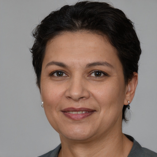 Joyful white adult female with medium  brown hair and brown eyes