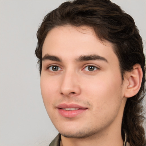 Joyful white young-adult male with medium  brown hair and brown eyes