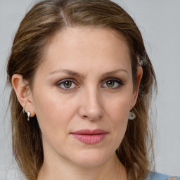 Joyful white young-adult female with medium  brown hair and blue eyes