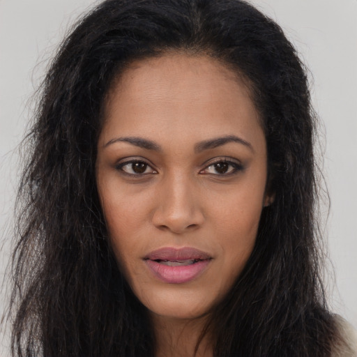 Joyful latino young-adult female with long  brown hair and brown eyes