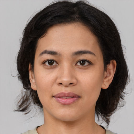 Joyful asian young-adult female with medium  brown hair and brown eyes