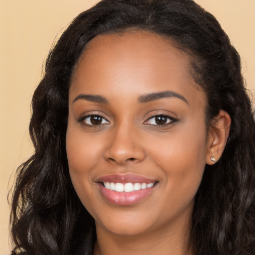 Joyful latino young-adult female with long  brown hair and brown eyes