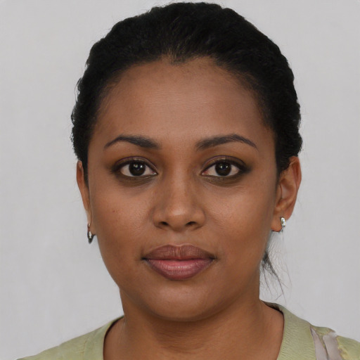 Joyful black young-adult female with short  black hair and brown eyes