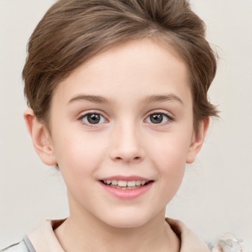 Joyful white child female with short  brown hair and brown eyes