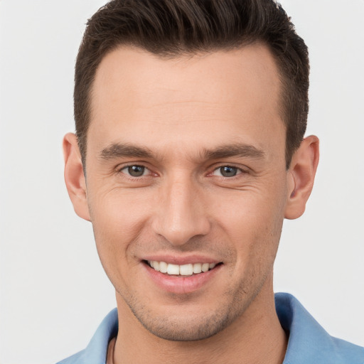 Joyful white young-adult male with short  brown hair and brown eyes