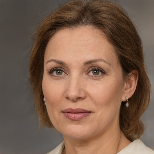 Joyful white adult female with medium  brown hair and brown eyes