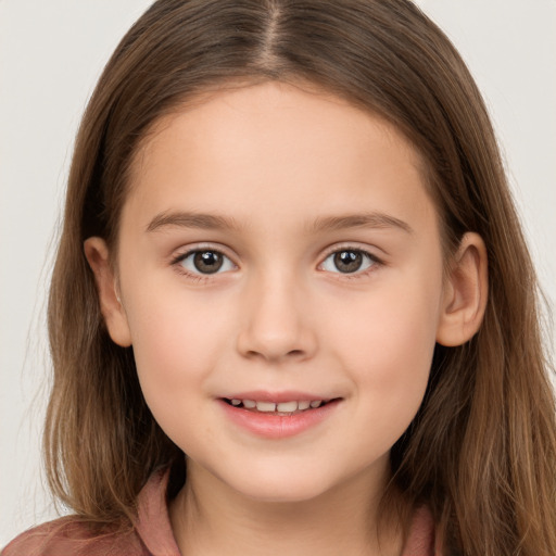 Joyful white child female with long  brown hair and brown eyes