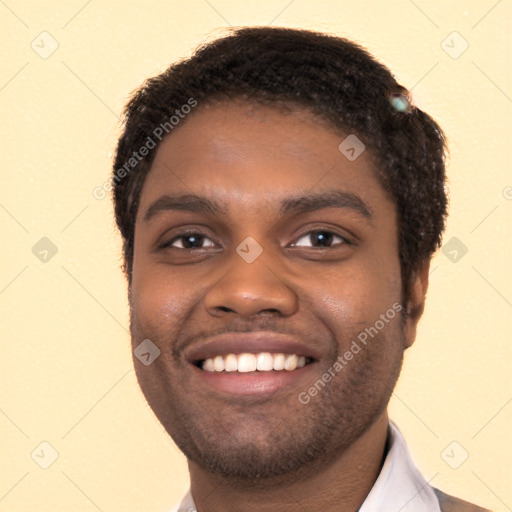 Joyful black young-adult male with short  black hair and brown eyes