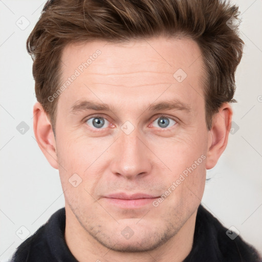 Joyful white adult male with short  brown hair and grey eyes