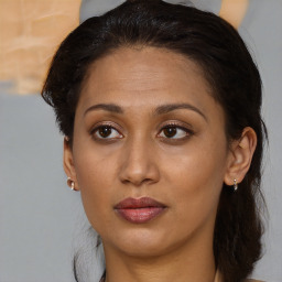 Joyful black adult female with medium  brown hair and brown eyes